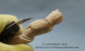 shaping a snake head in wood carving