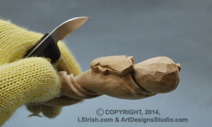 shaping a snake head in wood carving