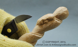 shaping a snake head in wood carving