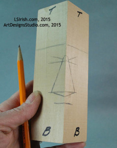 marking the guidelines for a wood spirit carving