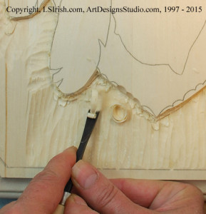 Straight chisel work for smoothing a wood carving