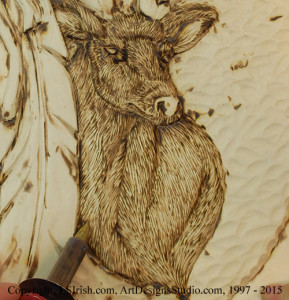 Wood burning the stop cuts of a wood carving relief