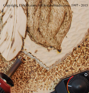 Detailing a wood carving with a pyrography burner