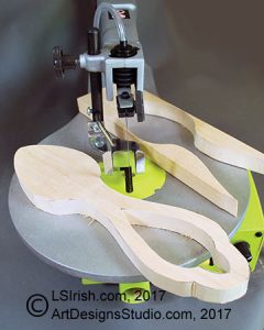 scroll saw cutting a wood carving spoon blank